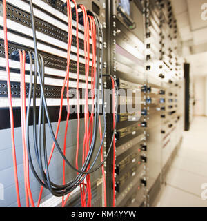 Close up of computer servers and cords in server room, a sterile secure environment server farm Stock Photo