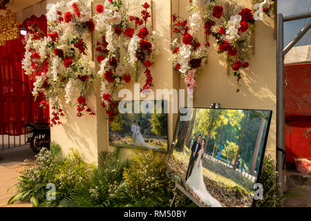 Cambodia, Kampot Province, Kampot, Road 736, portraits and floral display outside wedding marquee Stock Photo