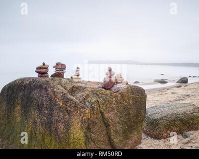 Zen stones pyramids in the beach. Stack of stone on the beach. Balance of soul Stock Photo