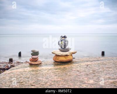 Zen stones pyramids in the beach. Stack of stone on the beach. Balance of soul Stock Photo