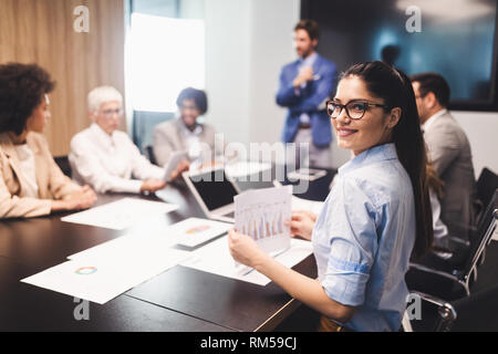Happy business colleagues in modern office working together Stock Photo