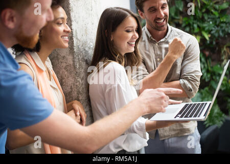 Programmers cooperating at IT company developing apps Stock Photo