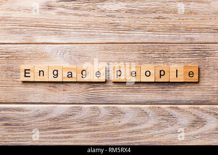 ENGAGE PEOPLE word written on wood block. ENGAGE PEOPLE text on wooden table for your desing, concept. Stock Photo