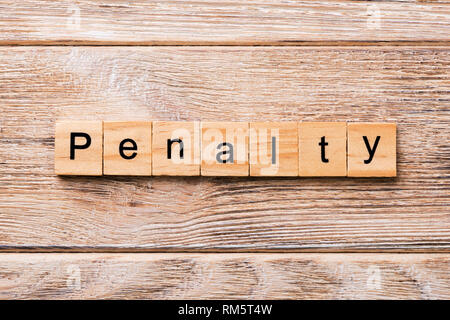 PENALTY word written on wood block. PENALTY text on wooden table for your desing, concept. Stock Photo