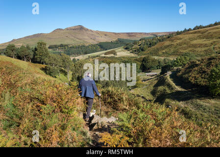 Man walking his dog in hills around Dove Stone reservoir, Greenfield, Peak District, England. Aldermans hill in the background. Stock Photo