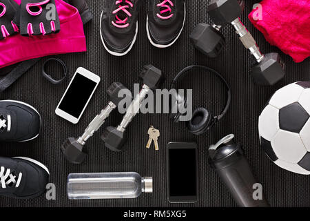 Fitness flat lay, female outfit background top view. Set of sport clothing and equipment for women, active lifestyle, body care concept Stock Photo