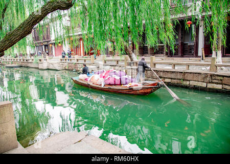ZHOUZHUANG,JIANGSU,CHINA - DECEMBER 14 2018 : unknown people on a Pick-up boat for the dry-cleaners in Zhouzhuang, is a town famous for its canals in  Stock Photo