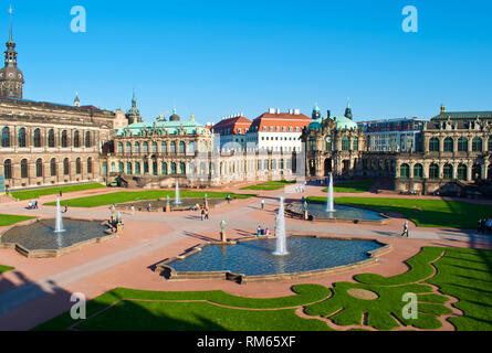 Courtyard of Zwinger gallery, Dresden, Germany. Picturesque Baroque architectural  buildings, four fountains, cut green grass. Cloudless spring day. S Stock Photo