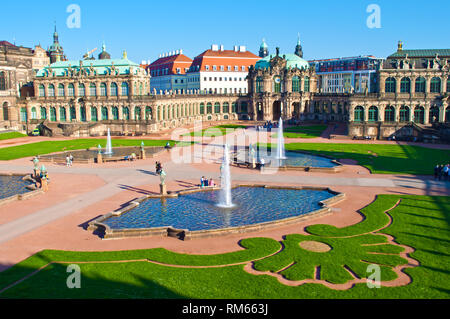 Courtyard of Zwinger gallery, Dresden, Germany. Picturesque Baroque architectural  buildings, four fountains, cut green grass. Cloudless spring day. S Stock Photo