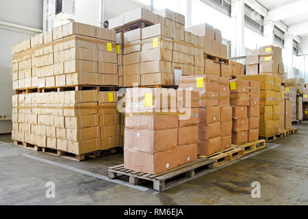 Big pile of boxes in storage room Stock Photo - Alamy