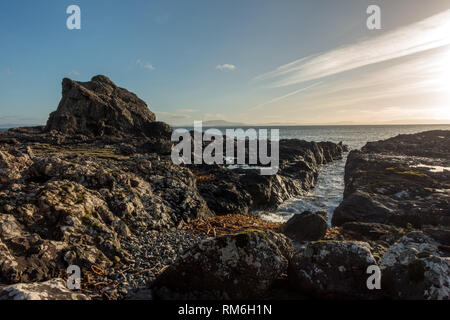 Coastal landscape scene (with basalt columns) from the Isle of Mull on the Carsaig coastline looking over to Islay and Jura, Scotland Stock Photo