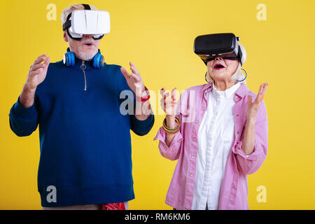 Pensioners feeling emotional while wearing virtual reality glasses Stock Photo