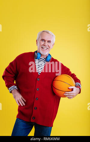 Man feeling excited before playing basketball with grandchildren Stock Photo