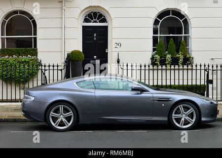 Expensive Aston Martin DB9 sports car outside luxury stucco fronted west london terraced residence, Eaton Terrace, Belgravia, West London SW1, United  Stock Photo