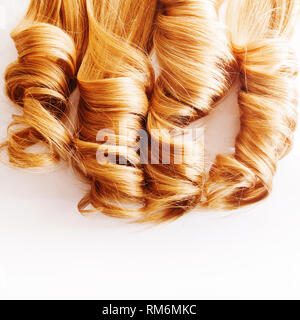 Curls curled on the Curling iron, isolated on white background. Strand of light or red hair, hair care, concept Stock Photo