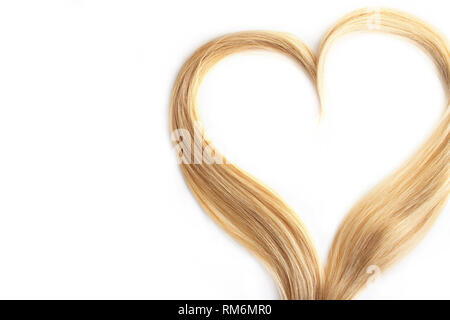 Strand of blond hair isolated on white. Curls of hair in the shape of a heart, health and hair care concept. Stock Photo
