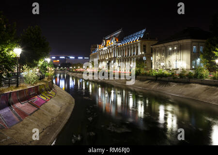 Bucharest, Romania. Palace of Justice in downtown at night, with Dambovita River in front, in summer Stock Photo