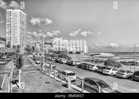CAPE TOWN, SOUTH AFRICA, AUGUST 17, 2018: A view of Beach Road and Sea Point in Cape Town. The Atlantic Ocean, buildings and vehicles are visible.  Mo Stock Photo