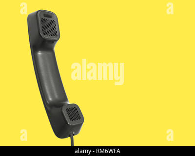 Black telephone receiver isolated on a pastel yellow background with ad copy space; Intercom, VOIP Stock Photo