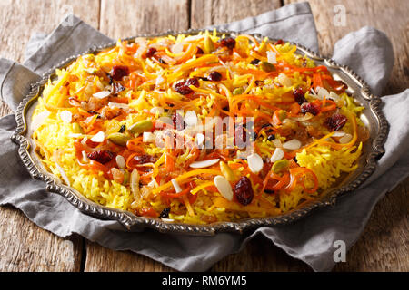 Iranian wedding pilaf Javaher Polow or jeweled rice close-up on a plate on the table. horizontal Stock Photo