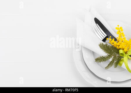 Spring table setting with mimosa easter holidays dinner Stock Photo