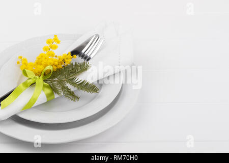 Spring table setting with mimosa easter holidays dinner Stock Photo