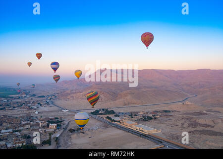Hot air balloons at sunrise over the Valley of the Kings, Luxor, Egypt Stock Photo
