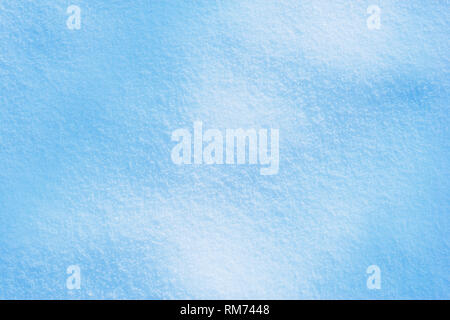 Background of sunny snow texture in blue tone. Stock Photo