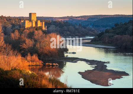 Almourol, Portugal - January 12, 2019: 12th century Almourol castle and Tagus river at sunset on a winter day. Stock Photo