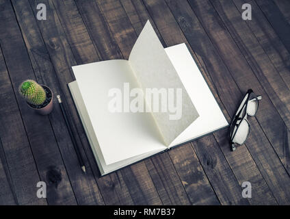 Blank booklet, stationery on vintage wood table background. Book, glasses, pencil and cactus. Responsive design mockup. Stock Photo