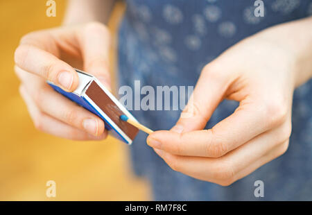Girl playing with matches. Dangerous situation at home. Stock Photo