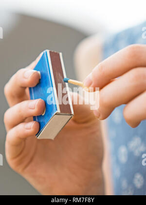 Girl playing with matches. Dangerous situation at home. Stock Photo