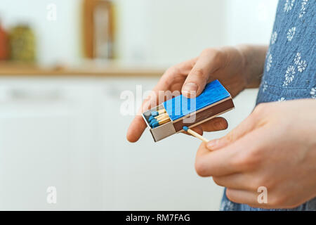 Girl playing with matches. Dangerous situation at home. A small