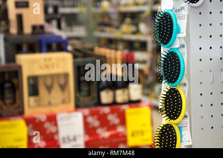 Colored hair brushes are sold. Combs for hair on a stand in a supermarket with copy space Stock Photo