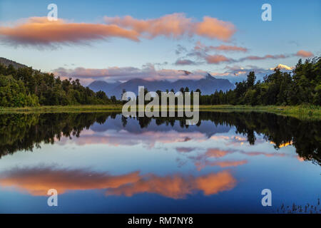 Lake Matheson is famous for the fact that seen from the northwest Aoraki/Mount Cook and Mount Tasman are reflected on the water surface.