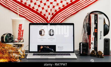 LONDON, UK - SEP 13, 2018: Creative room table with Safari Browser on MacBook Pro laptop showcasing Apple Computers website latest Apple Watch series 4 gold and space gray watch Stock Photo