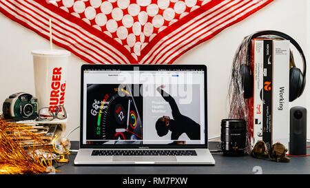 LONDON, UK - SEP 13, 2018: Creative room table with Safari Browser on MacBook Pro laptop showcasing Apple Computers website latest Apple Watch series 4 all new design Stock Photo