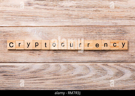Cryptocurrency word written on wood block. Cryptocurrency text on wooden table for your desing, concept. Stock Photo