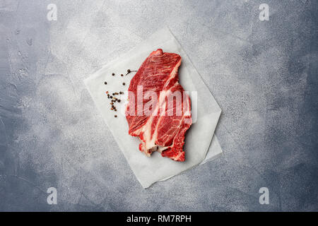 Organic fresh beef steak meat with thyme and pepper on gray marble background. View from above. Table top composition. Concept of tasty man food Stock Photo