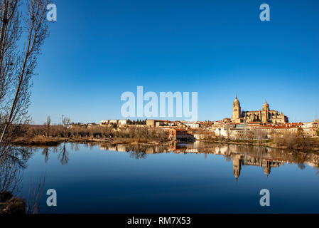 Beautiful panoramic view of the historic city of Salamanca with Rio Tormes , Cathedral and roman bridge in winter, Spain Stock Photo