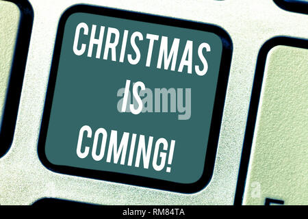 Word writing text Christmas Is Coming. Business concept for annual Christian festival celebrating Christs birth here Keyboard key Intention to create  Stock Photo