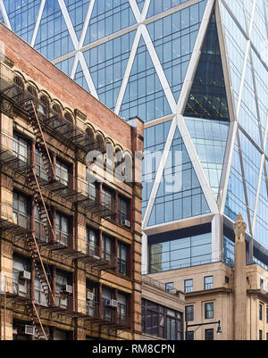 An old building with fire escapes in contrast to modern architecture in New York City, USA. Stock Photo