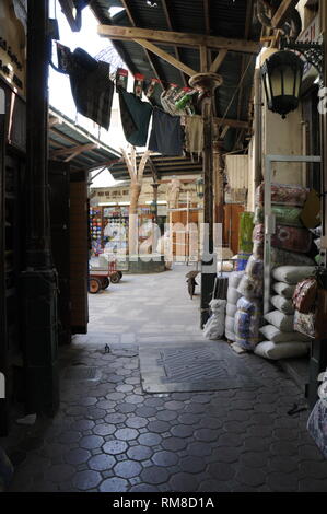 Interior of the Dubai Spice Souk or the Old Souk with rows of small businesses where a large assortment of goods are bought and sold on Baniyas Street Stock Photo