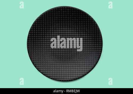 Black plate on mint green colored background, clipping path included, view directly from above Stock Photo