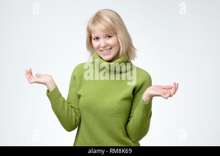 Woman with happy surprise on her face spreading her hands to the side Stock Photo