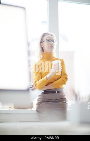 Businesswoman Daydreaming in Office Stock Photo