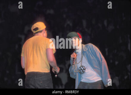The Beastie Boys are shown performing on stage during a "live" concert appearance. Stock Photo