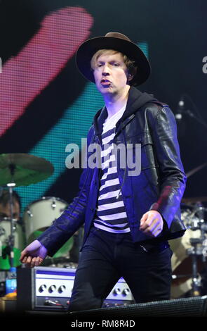 Beck is shown performing on stage during a 