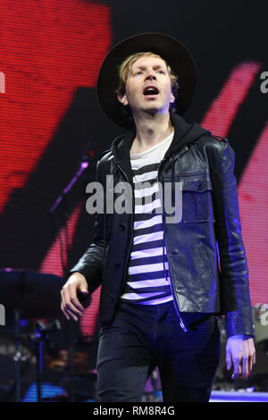 Beck is shown performing on stage during a 