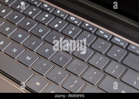Opened laptop keyboard, touchpad and empty mirror screen of black opened laptop top view closeup Stock Photo